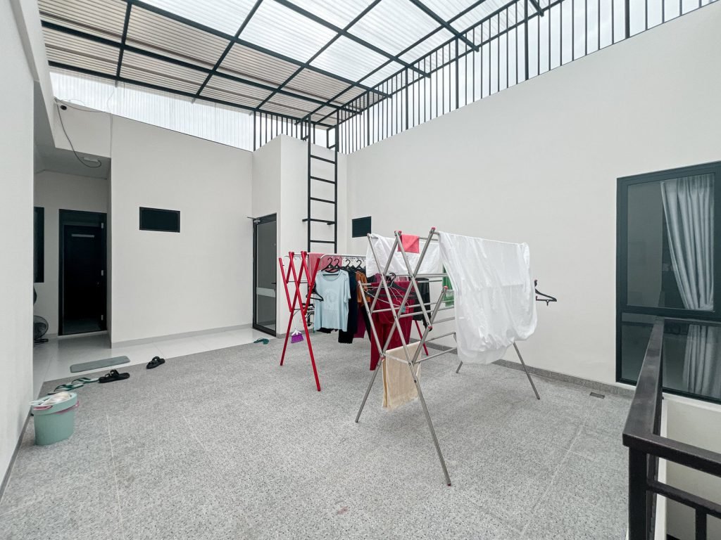 The covered rooftop laundry space at Arcelon Premiere with drying racks