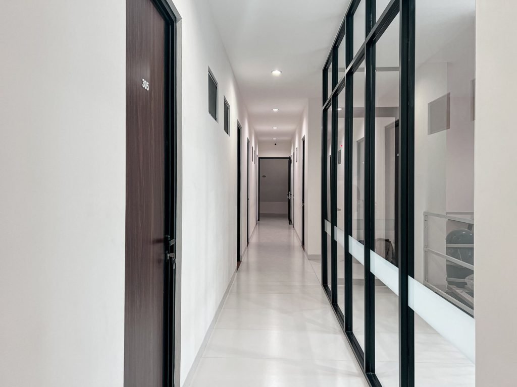 A residents corridor at Arcelon Premiere lined with room doors