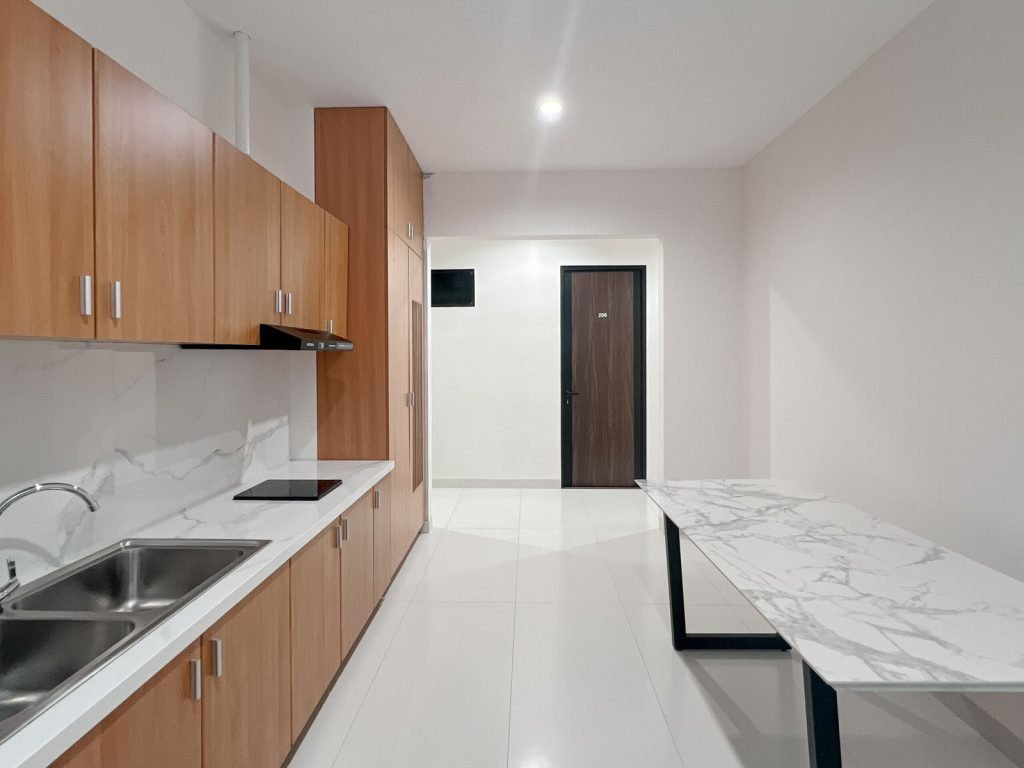 The kitchen counter, sink and hob in the communal kitchen at Arcelon Premiere