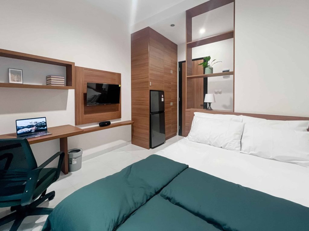 A Superior room at Arcelon Premiere with a queen bed, work desk and wall-mounted television