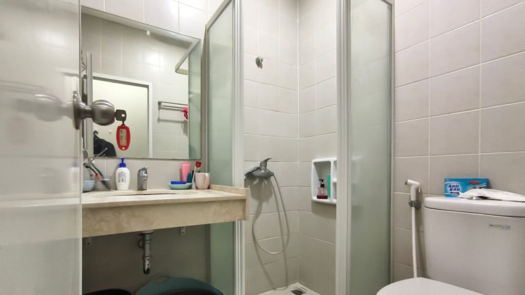 A private bathroom at Arcelon Premiere with a washbowl, mirror, shower and toilet