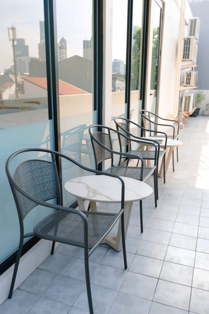Rooftop terrace seating at Arcelon Executive with the Jakarta skyline behind