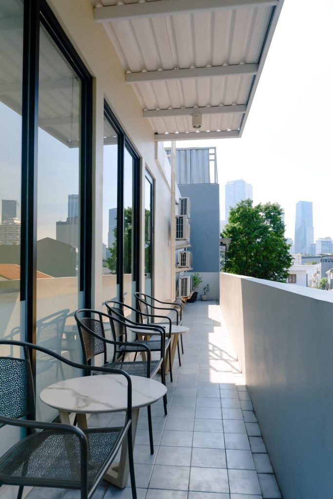 The rooftop walkway and seating at Arcelon Executive with the city skyline in the distance