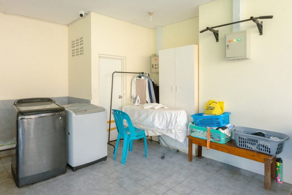 The shared laundry area at Arcelon Executive with washing machines and drying racks