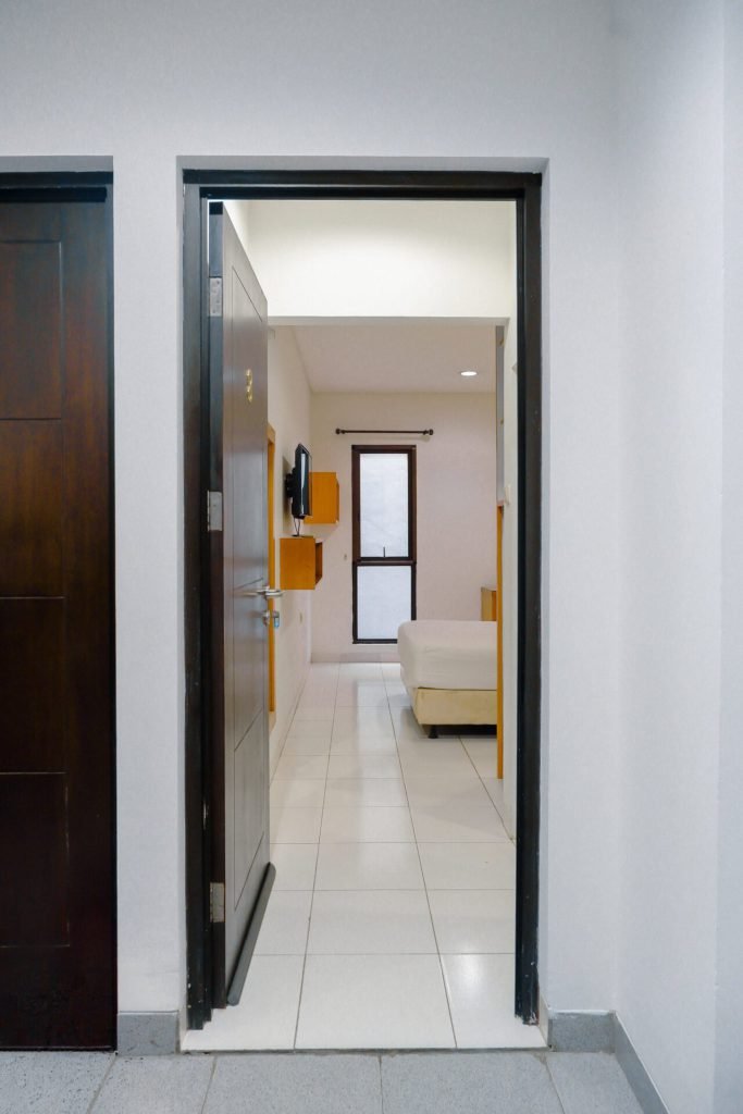 The doorway of a room at Arcelon Executive, looking through to the bed