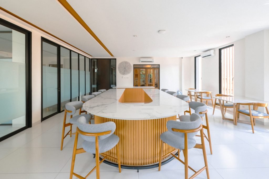 The coffee lounge at Arcelon Premiere with a marble island counter and bar stools
