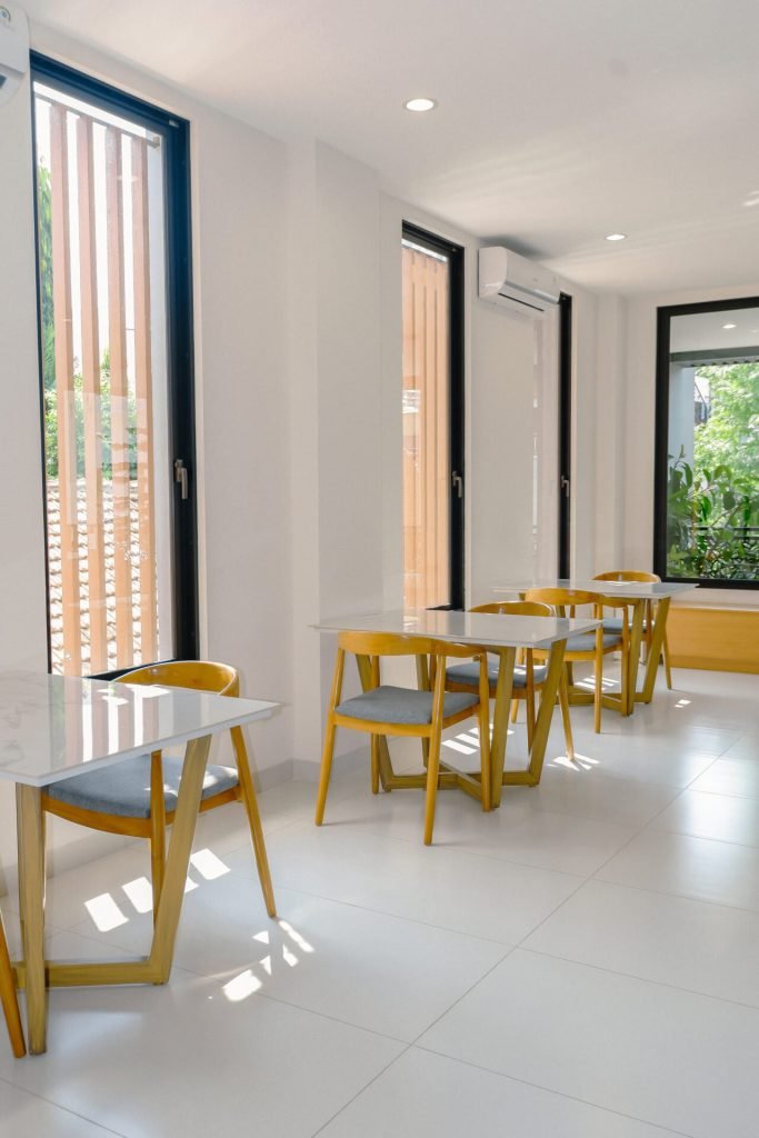 Dining tables beside the windows in the coffee lounge at Arcelon Premiere