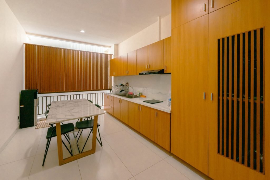 The communal kitchen and pantry at Arcelon Premiere with timber cabinetry