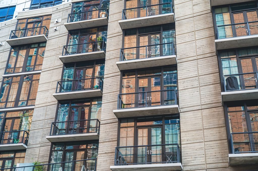 The facade of a modern apartment building with glass balconies