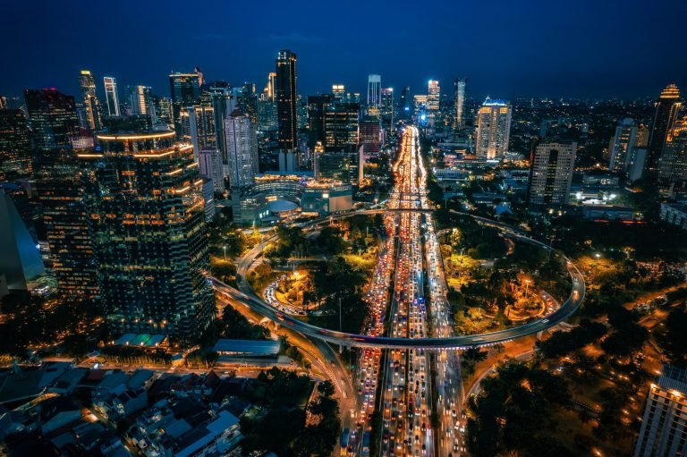 Aerial view of Central Jakarta's skyline and traffic-lit streets at night