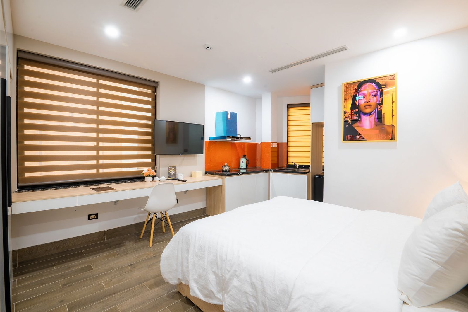 A bright modern room with a made bed and daylight from a window