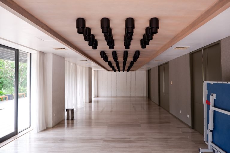 Multi-function hall with a mirrored ceiling feature and sliding doors onto the terrace
