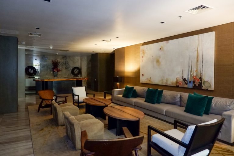 Residents' lounge with sofas, armchairs and a large canvas artwork above the seating