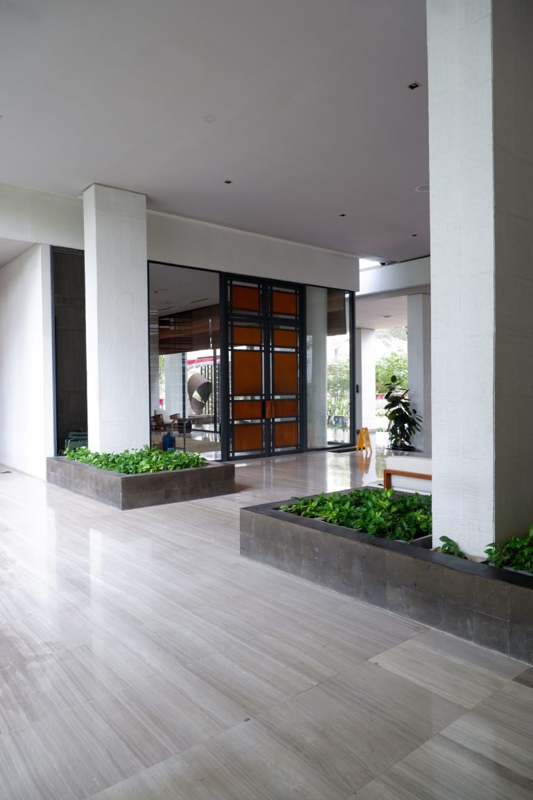 Building entrance seen from the garden path, with planting to either side