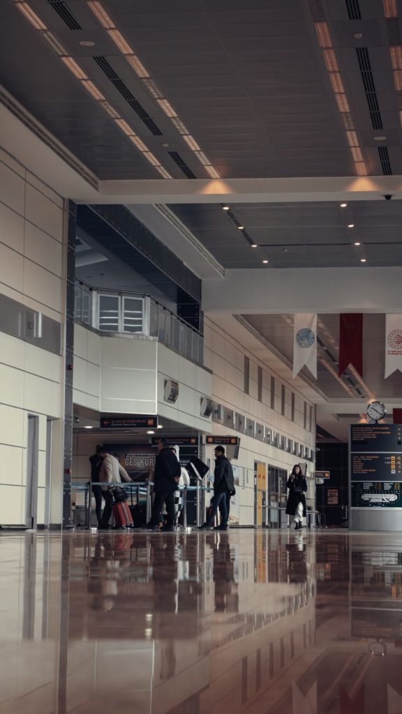 Travellers walking through a modern airport terminal