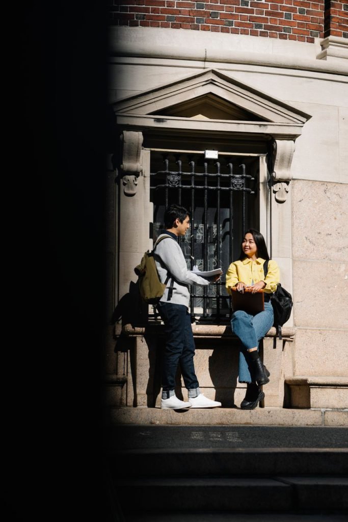Two university students talking outdoors on campus
