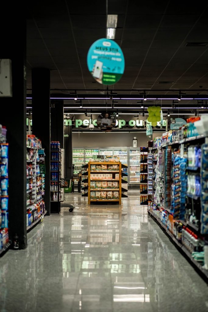 A well-lit supermarket aisle with stocked shelves