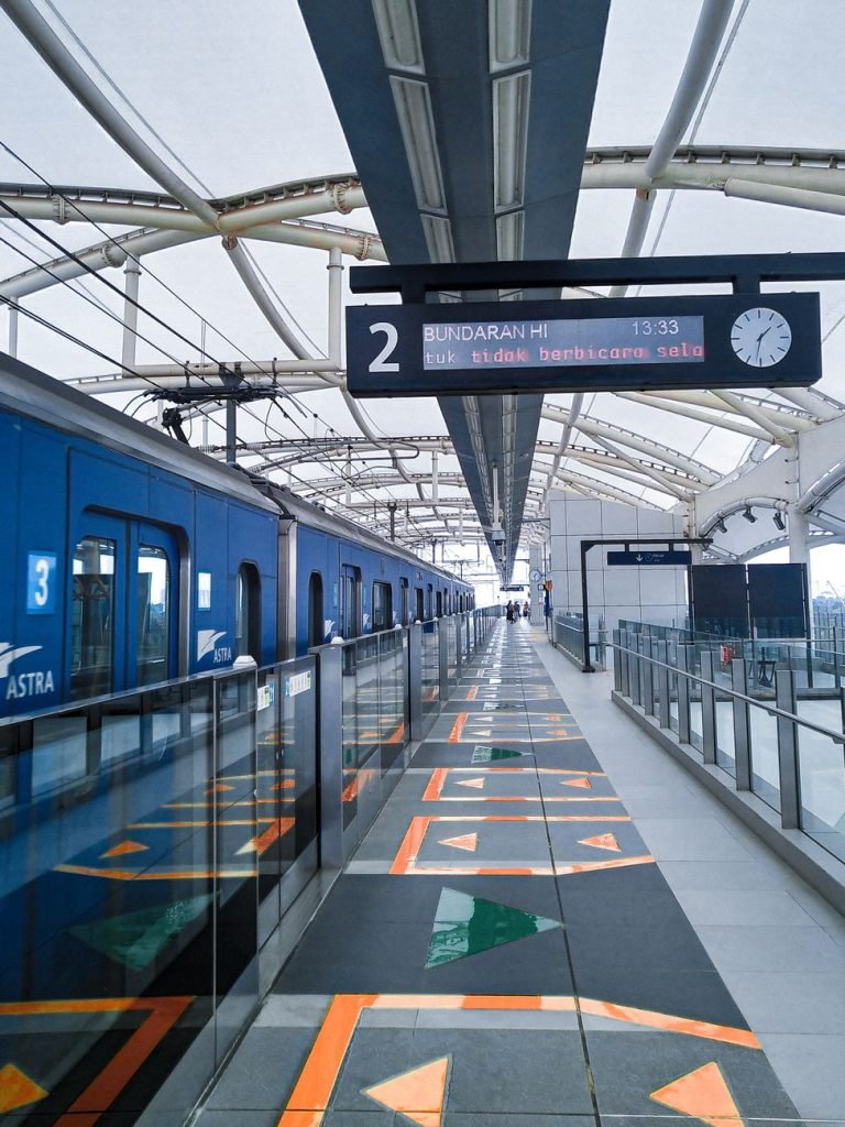 A Jakarta MRT station platform with a train arriving
