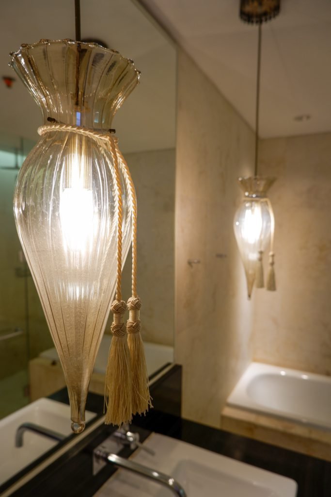 Glass pendant lights above the bathroom vanity, reflected in the mirror