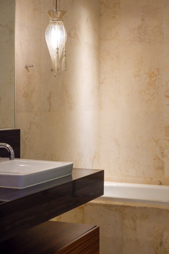 Bathroom vanity detail with pendant light and stone counter