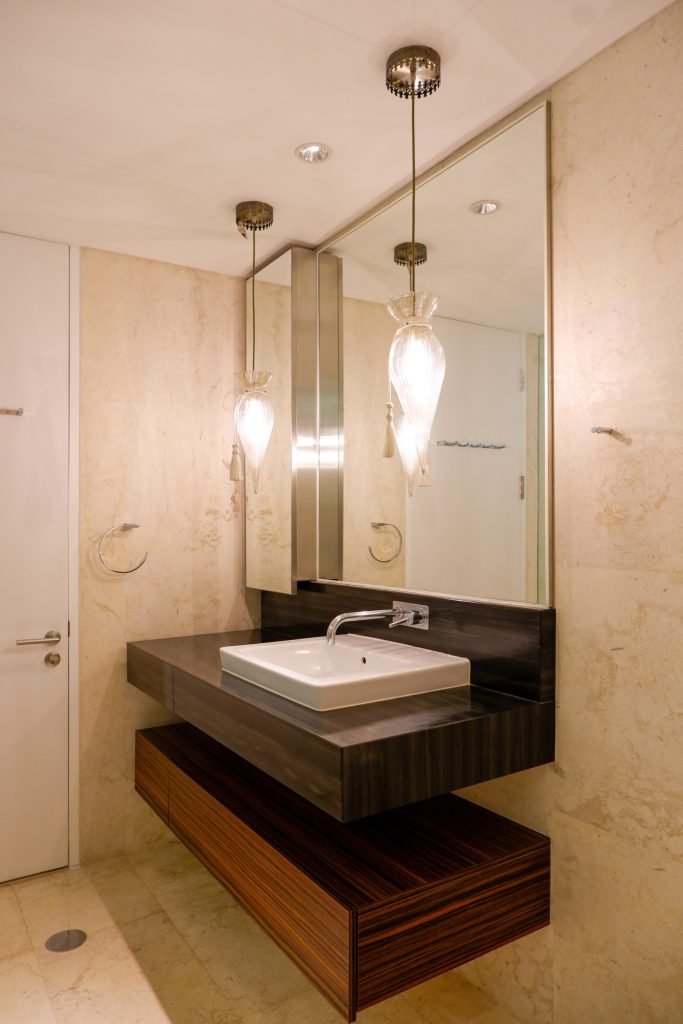 Twin pendant lights over the bathroom mirror and basin